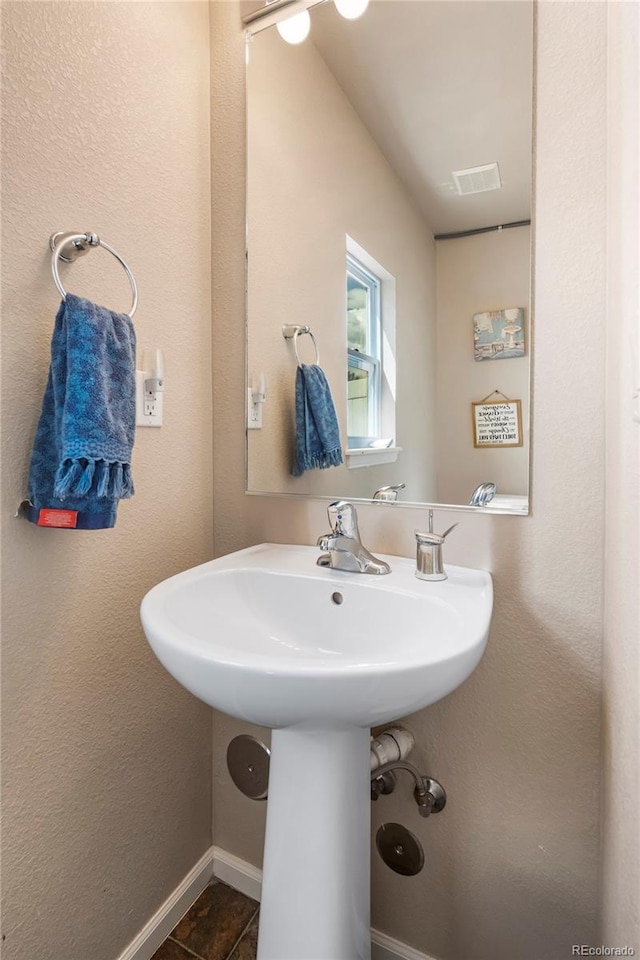 20414 E 55th Pl, Denver, CO 80249 - bathroom featuring baseboards and tile patterned flooring