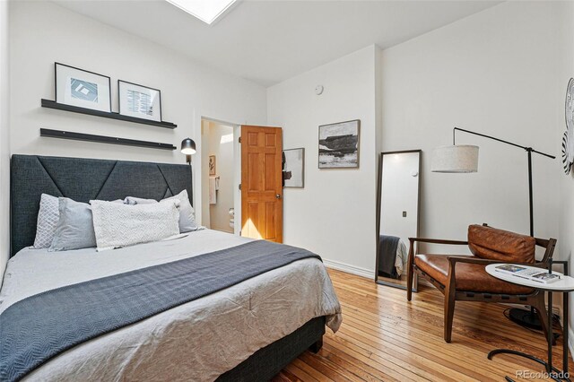 bedroom featuring light wood-style floors and baseboards