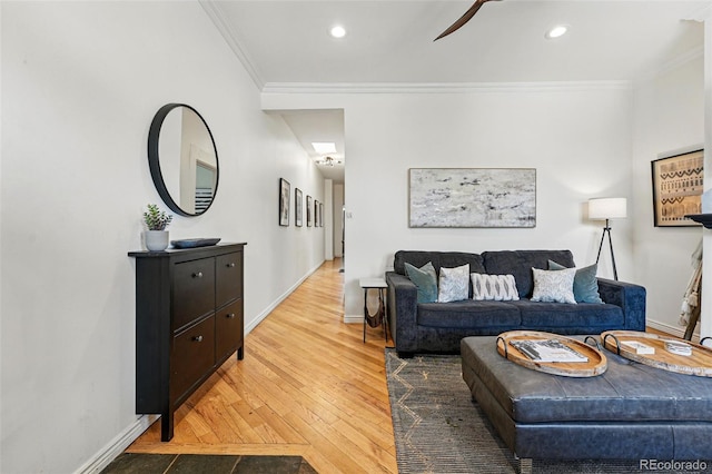 living room featuring baseboards, ornamental molding, and hardwood / wood-style floors
