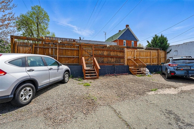 view of parking / parking lot with fence