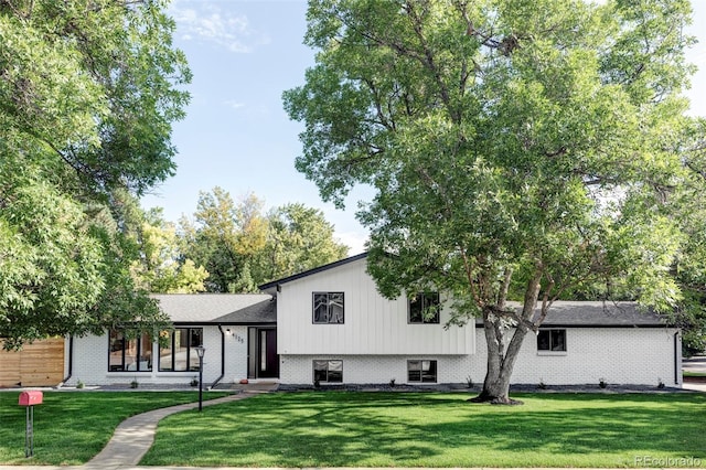 split level home with a front yard