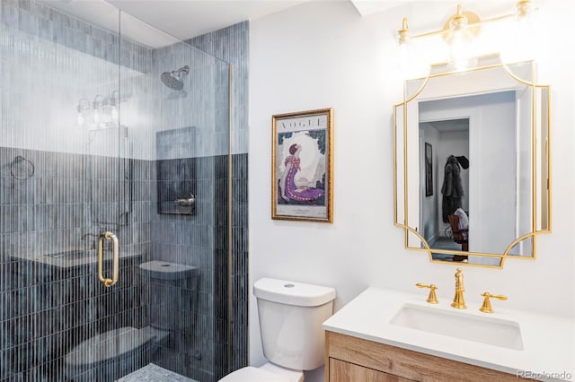 bathroom with a shower with door, vanity, and toilet