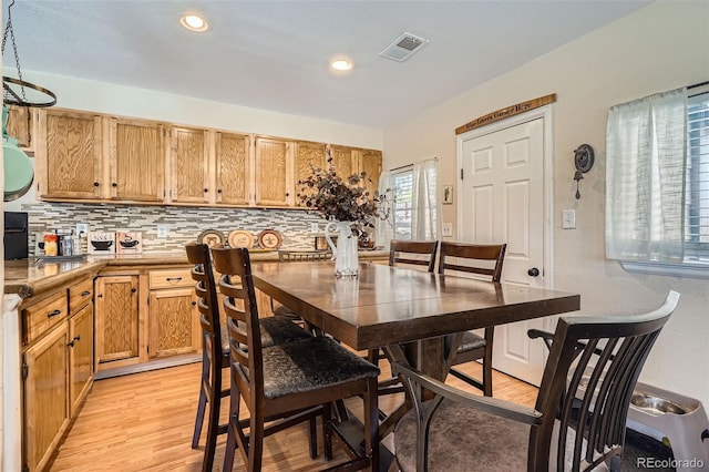 dining room featuring light wood finished floors, visible vents, and recessed lighting