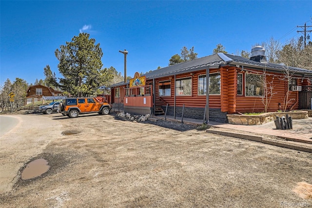 log home with log veneer siding and metal roof