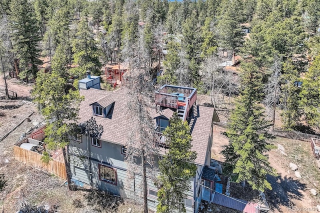 aerial view of property and surrounding area with a forest