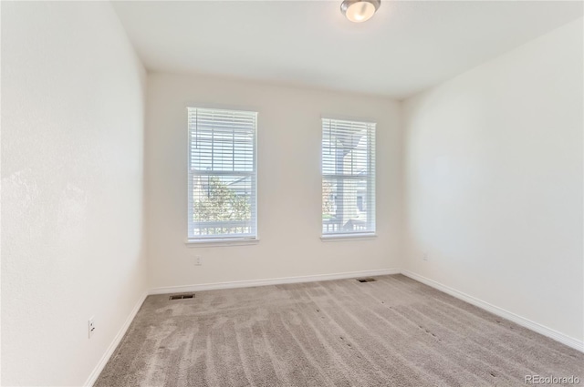 spare room with light colored carpet