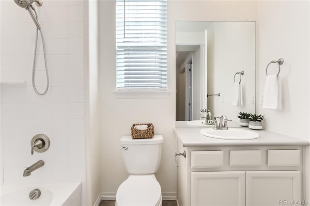 full bathroom featuring vanity, toilet, and tiled shower / bath