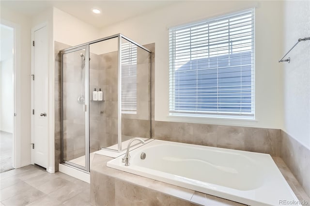 bathroom with shower with separate bathtub