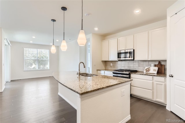 kitchen featuring white cabinets, sink, an island with sink, and stainless steel appliances