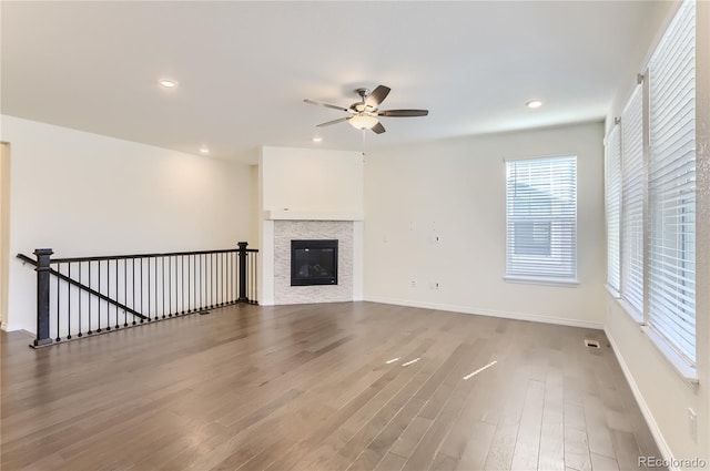 unfurnished living room with ceiling fan and wood-type flooring