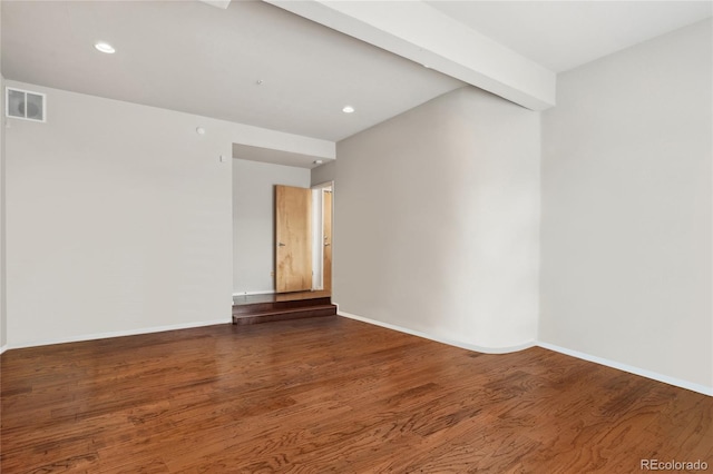 unfurnished room featuring visible vents, wood finished floors, baseboards, and recessed lighting