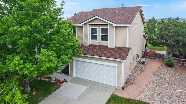 7270 Marmot Ridge Pl, Littleton, CO 80125 - view of front of house featuring roof with shingles, a garage, and driveway