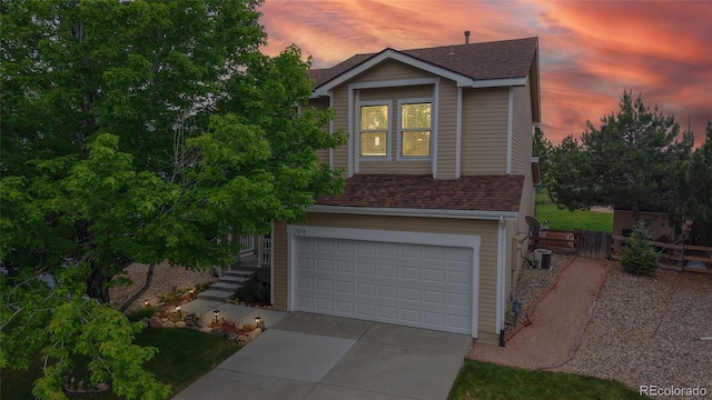 7270 Marmot Ridge Pl, Littleton, CO 80125 - traditional-style house featuring roof with shingles, a garage, and driveway
