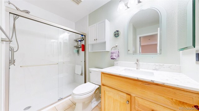 7270 Marmot Ridge Pl, Littleton, CO 80125 - full bathroom with vanity, a stall shower, and tile patterned flooring