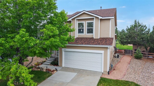 7270 Marmot Ridge Pl, Littleton, CO 80125 - view of front facade featuring a shingled roof, a garage, and concrete driveway