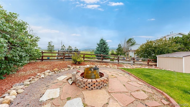 7270 Marmot Ridge Pl, Littleton, CO 80125 - fenced backyard featuring a patio, a shed, and a fire pit