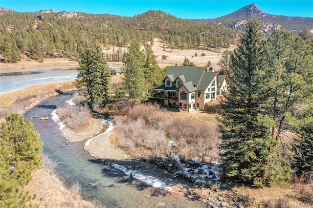 aerial view featuring a water view and a forest view