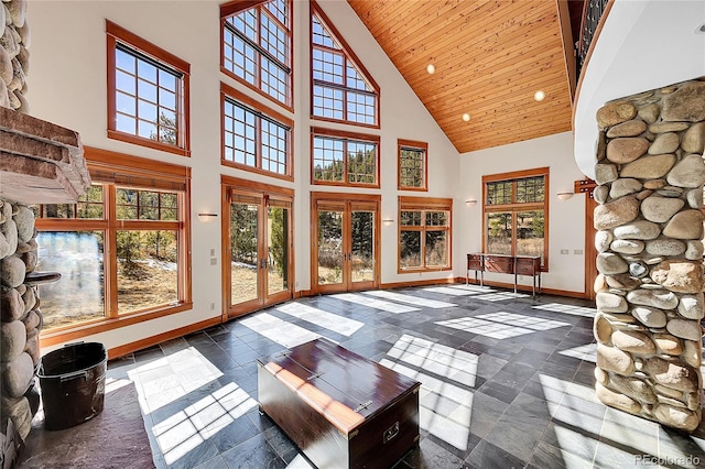 unfurnished sunroom with plenty of natural light, french doors, vaulted ceiling, and wooden ceiling