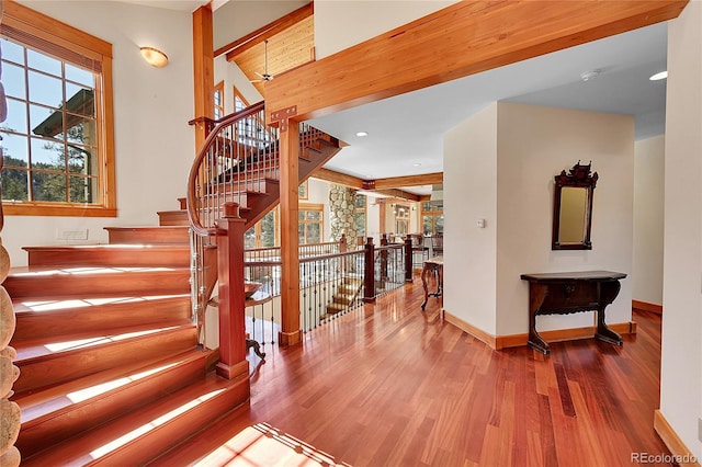 stairs with recessed lighting, baseboards, and wood finished floors