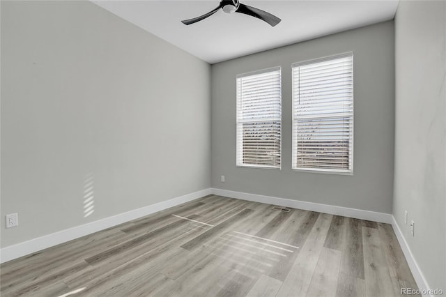 empty room featuring ceiling fan and light hardwood / wood-style floors