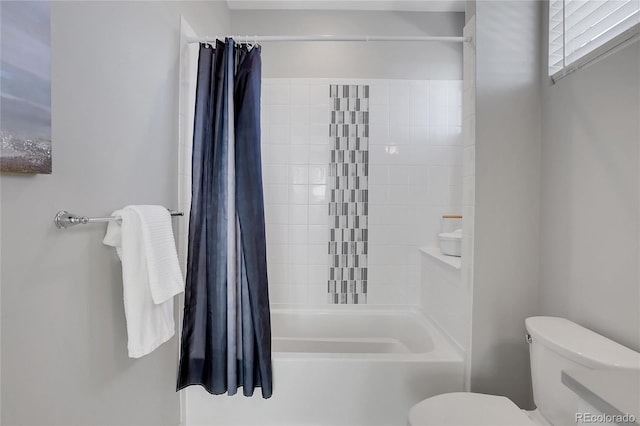 bathroom with shower / tub combo and toilet