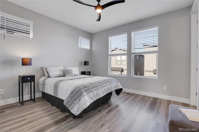 bedroom with light hardwood / wood-style flooring and ceiling fan