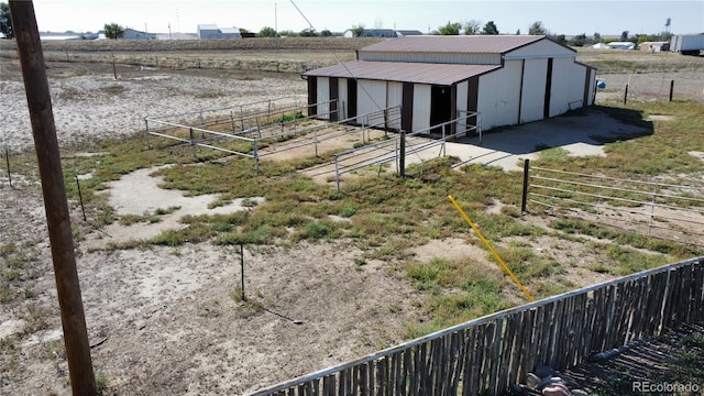 view of yard with a rural view and an outbuilding