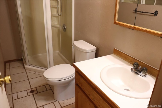 bathroom with vanity, toilet, tile patterned floors, and a shower with door