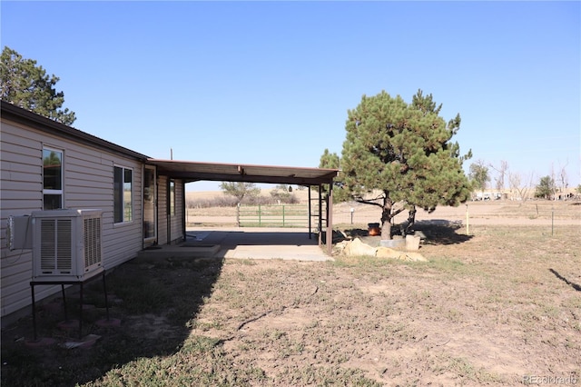 view of yard with central air condition unit and a rural view