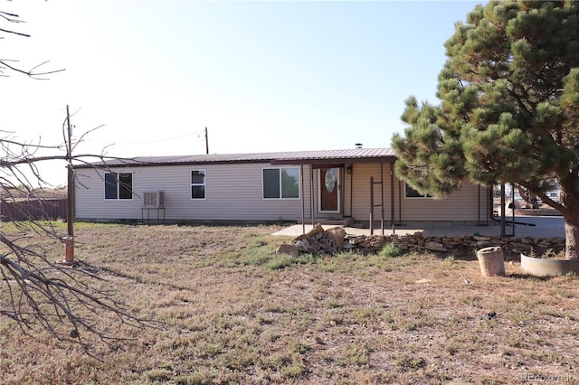 back of property with a patio