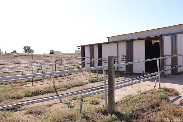 view of stable featuring a rural view