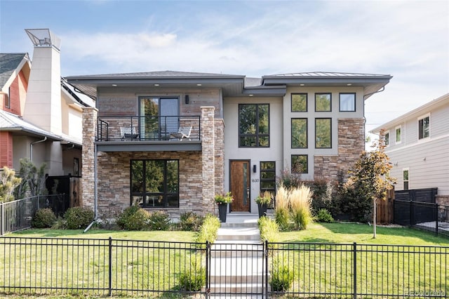 view of front of property featuring a balcony and a front yard