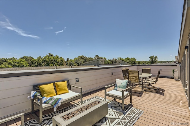 4100 E Iliff Ave Unit 4, Denver, CO 80222 - deck featuring an outdoor living space with a fire pit, view of scattered trees, and outdoor dining area