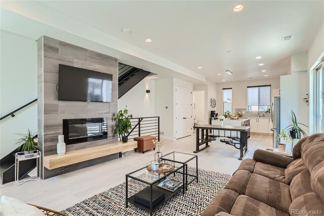 4100 E Iliff Ave Unit 4, Denver, CO 80222 - living room featuring recessed lighting, a fireplace, baseboards, and light wood finished floors
