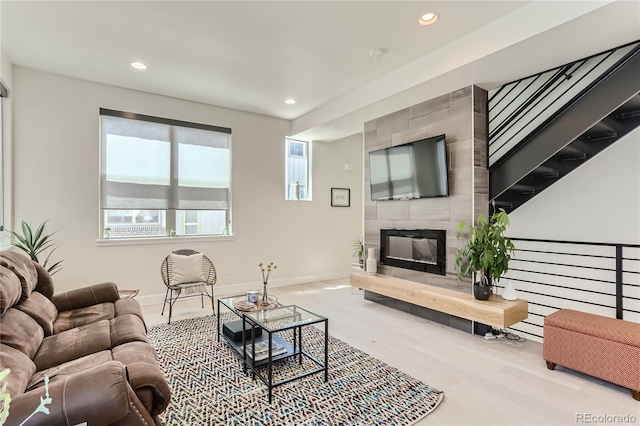 4100 E Iliff Ave Unit 4, Denver, CO 80222 - living room featuring baseboards, recessed lighting, wood finished floors, and a tile fireplace