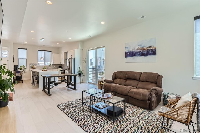 4100 E Iliff Ave Unit 4, Denver, CO 80222 - living area featuring healthy amount of natural light, light wood-type flooring, and recessed lighting