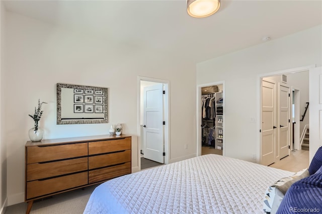 4100 E Iliff Ave Unit 4, Denver, CO 80222 - bedroom featuring a walk in closet, a closet, and baseboards