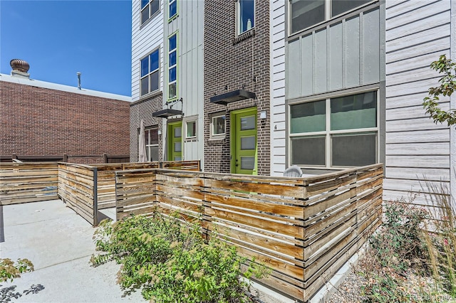 4100 E Iliff Ave Unit 4, Denver, CO 80222 - doorway to property featuring board and batten siding and brick siding