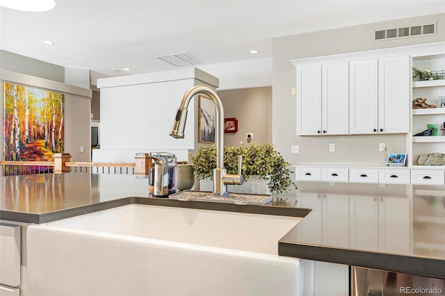 kitchen with white cabinetry and sink