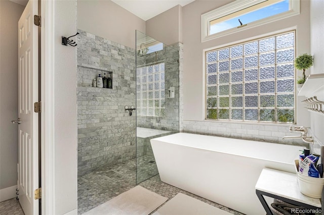 bathroom with separate shower and tub