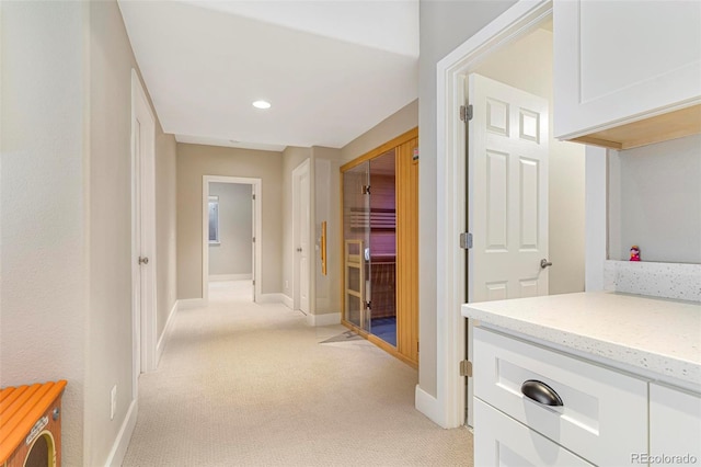 hallway featuring light colored carpet