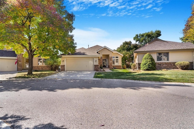 single story home featuring a garage and a front lawn