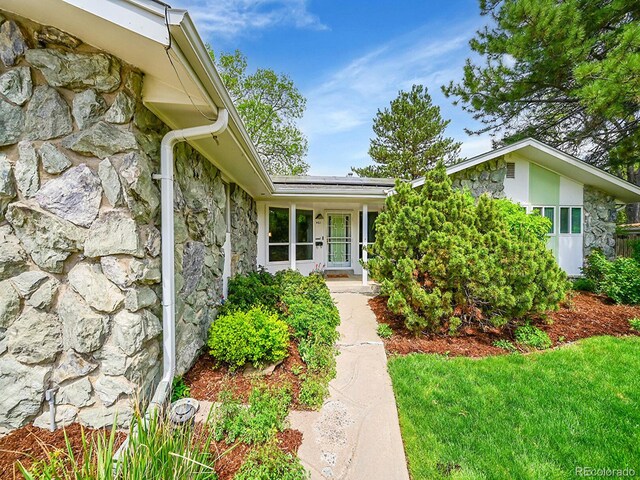461 Nome St, Aurora, CO 80010 - entrance to property with stone siding and solar panels