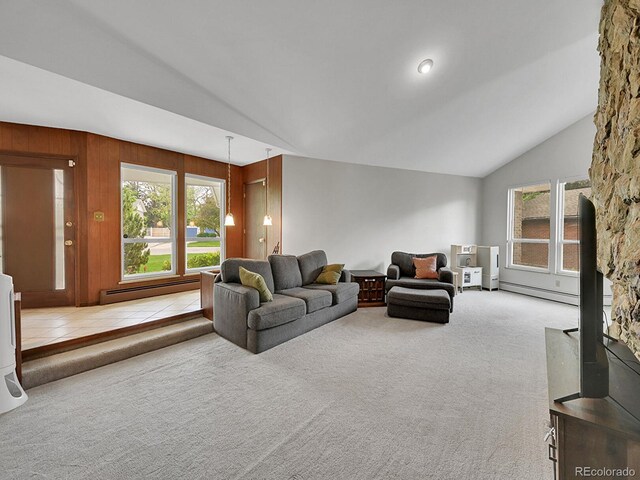 461 Nome St, Aurora, CO 80010 - living area with vaulted ceiling, a baseboard radiator, plenty of natural light, and carpet