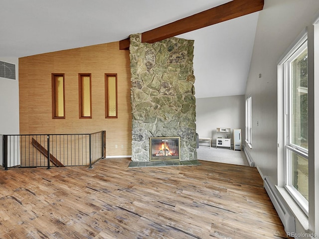 461 Nome St, Aurora, CO 80010 - unfurnished living room with a baseboard radiator, high vaulted ceiling, wood finished floors, a fireplace, and beam ceiling