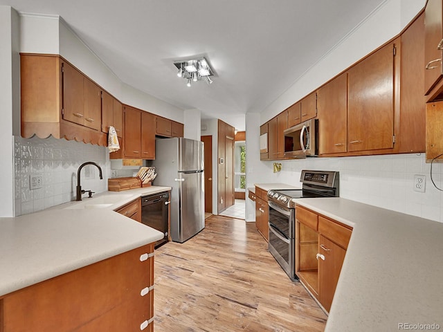 461 Nome St, Aurora, CO 80010 - kitchen with appliances with stainless steel finishes, a sink, backsplash, and light countertops
