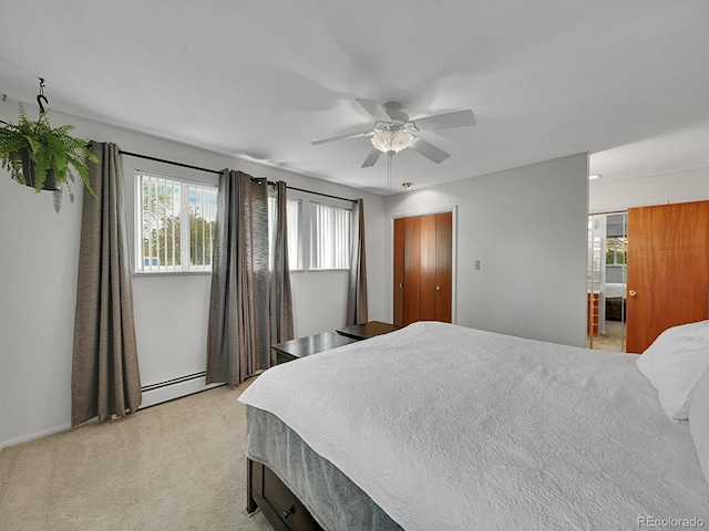461 Nome St, Aurora, CO 80010 - bedroom with multiple windows, a baseboard heating unit, light carpet, and ensuite bath