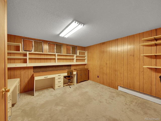 461 Nome St, Aurora, CO 80010 - unfurnished office featuring built in desk, wooden walls, a baseboard radiator, a textured ceiling, and carpet
