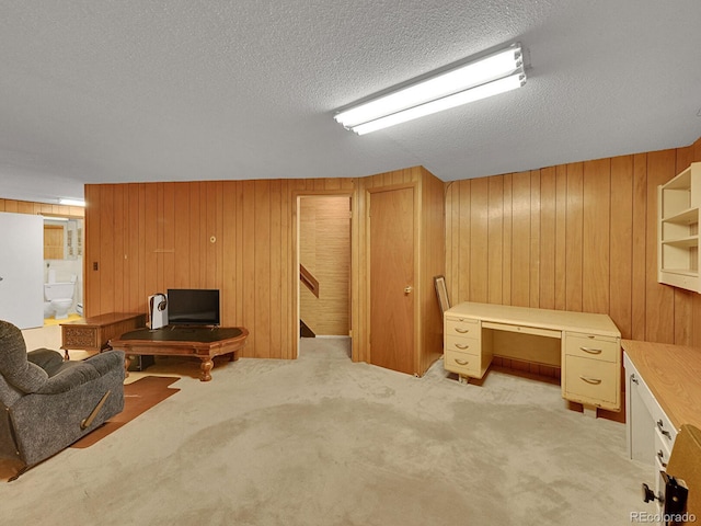 461 Nome St, Aurora, CO 80010 - home office with wooden walls, light colored carpet, and a textured ceiling