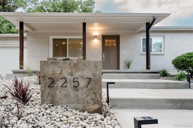 2257 S Lowell Blvd, Denver, CO 80219 - view of exterior entry with brick siding and covered porch